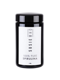 Black container of Susie Who 100% Pure Spirulina on a white background